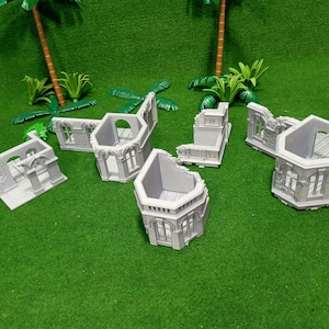 May include: A set of six gray plastic model building ruins. The ruins are in various shapes and sizes, and some have windows and doors. The ruins are on a green surface.
