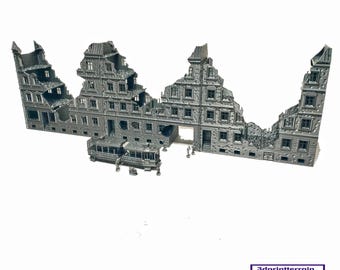 May include: A detailed model of a ruined building, made of gray plastic. The building is broken into several sections, with visible windows and doors. A small model tram is in the foreground.
