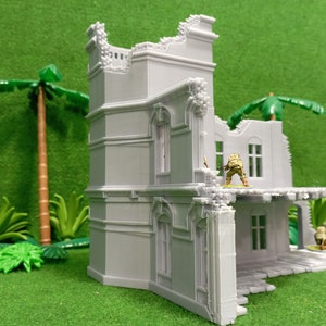 May include: A detailed, gray, 3D printed model of a ruined building with a balcony and a palm tree in the background. The building has a broken window and a collapsed roof. The model is made by WOW Buildings.