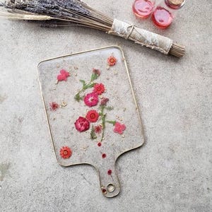 clear resin Charcuterie board with red flowers.