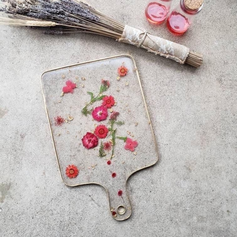 clear resin Charcuterie board with red flowers.