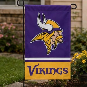 May include: A rectangular garden flag featuring a purple background with a white horizontal stripe and a yellow bottom section. The flag displays the Minnesota Vikings logo, a profile of a Viking with a yellow helmet and white horns, and the word VIKINGS.