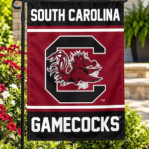 May include: A vertical garden flag featuring the text SOUTH CAROLINA at the top and GAMECOCKS at the bottom in white block letters. The centre displays a large black letter C with a maroon gamecock graphic inside, set against a maroon background.