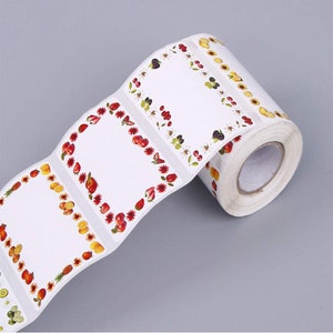 May include: Roll of white sticker labels with a colourful fruit border. The labels are blank and ready to be written on.