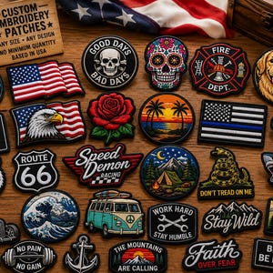 May include: A collection of various embroidered patches featuring diverse designs including a skull, a rose, a golden retriever, an astronaut, a shark, a tiger, a camper van, mountains, and American flags, with a wooden sign reading Custom Embroidery Patches.