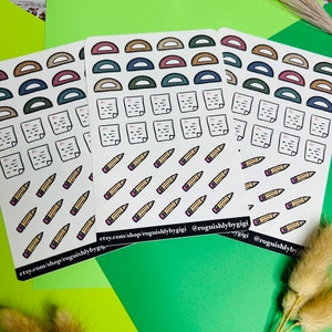 May include: Three sheets of stickers with a school theme. The stickers feature protractors, pencils, and papers with the letter A+ on them. The stickers are white with black outlines and colorful accents. The text on the stickers reads "etsy.com/shop/roguishlybygigi @roguishlybygigi".