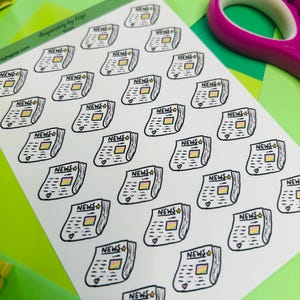 May include: A sticker sheet featuring multiple small, hand-drawn illustrations of newspapers. Each newspaper icon is outlined in black, labeled with the word NEWS, and includes a small rainbow-colored square and a tiny heart at the bottom corner.