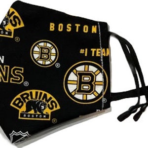 May include: Black face mask with a repeated pattern of the Boston Bruins logo, the team name, and the words "#1 Team".
