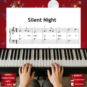 May include: A piano keyboard with the sheet music for "Silent Night" displayed. The sheet music is white with black notes and text. The text "Silent Night" is at the top. The piano keys are black and white. The image includes the text "GRADE I PIANO SCORE + MP3 + VIDEO".