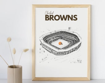 Puede incluir: Impresión enmarcada con una ilustración en blanco y negro de un estadio, con un casco de fútbol americano marrón en el centro. Las palabras "Cleveland BROWNS" están impresas en marrón en la parte superior. El marco es de madera clara.