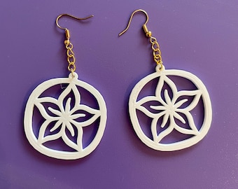 May include: A pair of white earrings with a gold chain and a flower design. The earrings are made of a lightweight material and have a delicate look.