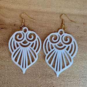 May include: A pair of white, openwork, heart-shaped earrings with gold hooks.