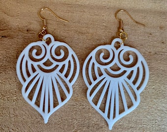 May include: A pair of white, openwork, heart-shaped earrings with gold hooks.