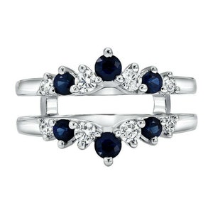 May include: A white gold ring enhancer with a double band design. The enhancer is adorned with a row of alternating blue sapphires and white diamonds on each band.