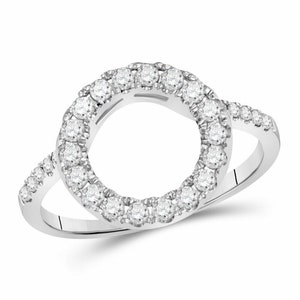 May include: A silver ring with a circle of diamonds surrounding a center opening. The ring is designed to hold a separate center stone.