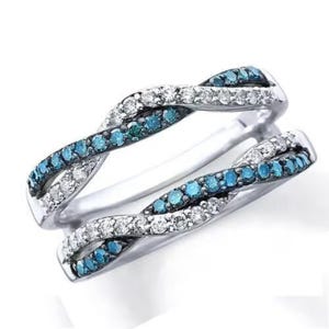May include: A silver ring with a twisted design featuring blue and white diamonds.