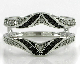 May include: A silver ring enhancer with a wave design featuring black and white diamonds.
