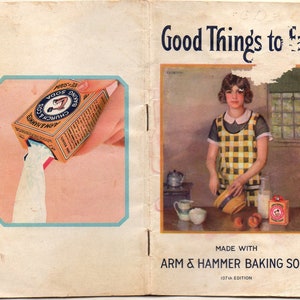 May include: Vintage advertisement for Arm & Hammer Baking Soda. The image shows a woman in a kitchen, wearing a yellow and black checkered apron. The advertisement includes the text "Good Things to Eat" and "Made with Arm & Hammer Baking Soda."