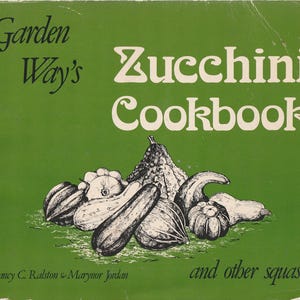 May include: A vintage cookbook titled "Garden Way's Zucchini Cookbook" with illustrations of various squash on a green background. The cover also includes the text "and other squash" and the names Nancy C. Ralston & Marynor Jordan.