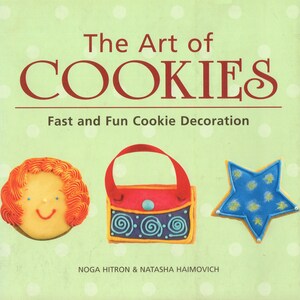 May include: The Art of Cookies book cover with a green background and white polka dots. The title is in red text. The subtitle is "Fast and Fun Cookie Decoration". There are three decorated cookies: a girl, a purse, and a star.