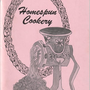 May include: A pink booklet with a black and white illustration of a meat grinder and the text "Homespun Cookery" in a decorative frame. The text "Avon Lake Junior Women's Club" is at the bottom of the page.