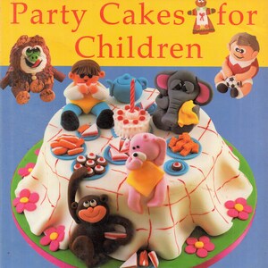 May include: A book cover featuring a colorful cake with various figurines, including a monkey, elephant, teddy bear, and a gingerbread person. The title of the book is "Carol Deacon's Party Cakes for Children" and the text "Over 20 fun cakes" is at the bottom of the cover.