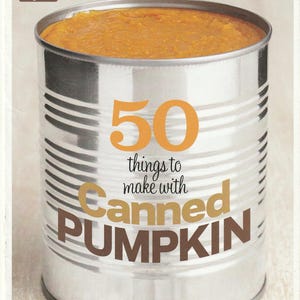 May include: A Food Network Magazine cover featuring a large can of pumpkin puree. The can is silver with horizontal ridges and the text "50 things to make with Canned PUMPKIN" in orange and brown. The top left corner has the Food Network logo.