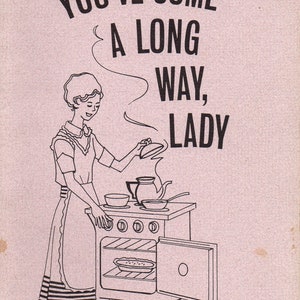 May include: A vintage-style illustration on a pink background. The image features a woman in an apron cooking at a stove, with the text "YOU'VE COME A LONG WAY, LADY" above her. The oven door is open, and a pie is visible inside.