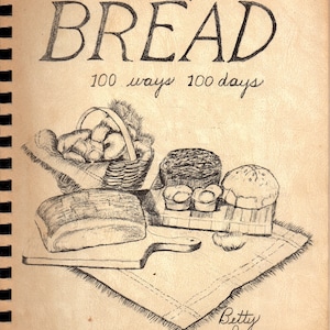 May include: A vintage cookbook cover titled "a diary of BREAD" with illustrations of various bread types, including loaves and rolls. The cover also includes the text "100 ways 100 days" and the author's name, Betty Janssen.