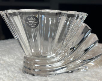 May include: A clear glass bowl with a fan-shaped design. The bowl is made of 24% lead crystal and is marked "Studio-Line Made in Germany 24% lead crystal".