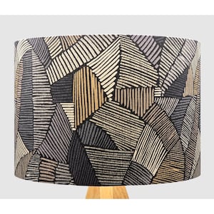 May include: A lampshade featuring a geometric pattern in shades of black, brown, and grey. The pattern is made up of stripes and lines creating a modern and abstract design.