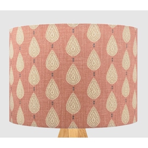 May include: A pink lampshade with a white and blue paisley pattern.