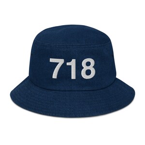 May include: A navy blue bucket hat with the number "718" embroidered in white on the front.