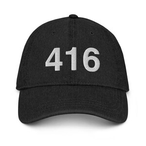 May include: A black baseball cap with white embroidered text that reads "416".