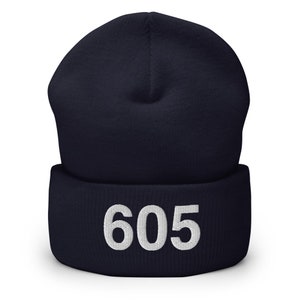 May include: Navy blue beanie with a white embroidered number 605.