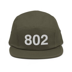 May include: A green 5-panel cap with a white embroidered number "802" on the front.