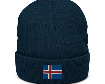 May include: A navy blue knitted beanie with a small Icelandic flag patch on the front.