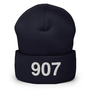 May include: Navy blue beanie with a white embroidered number 907.