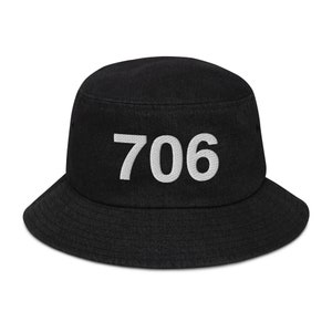 May include: A black bucket hat with the number 706 embroidered in white on the front.