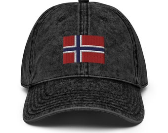 May include: A black distressed denim baseball cap with an embroidered Norwegian flag in red, white, and blue.