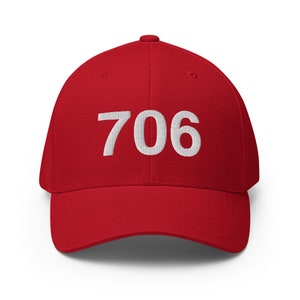 May include: A red baseball cap with the number 706 embroidered in white on the front.