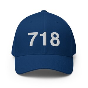 May include: A navy blue baseball cap with the number "718" embroidered in white on the front.