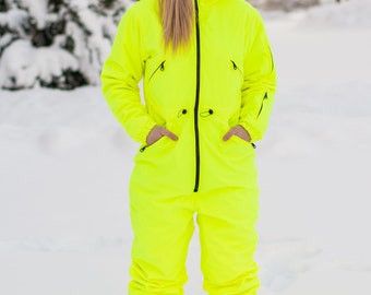 May include: A bright yellow snowsuit with a black zipper and black accents. The snowsuit has a hood and pockets.