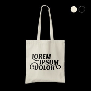 Puede incluir: Una bolsa de lona blanca con texto negro que dice "LOREM IPSUM DOLOR" en una fuente retro.