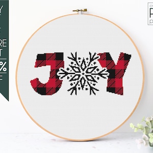 May include: Cross-stitch pattern for the word "JOY" in red and black buffalo plaid with a snowflake in the center. The pattern is displayed on a wooden embroidery hoop.