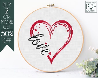 May include: Cross-stitch pattern PDF for a red heart with the word "love" written inside. The pattern is displayed in a wooden embroidery hoop.