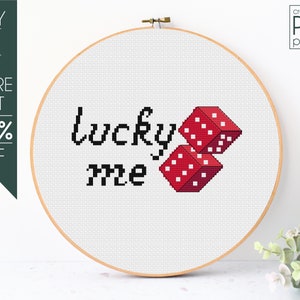 Pode incluir: Padrão de ponto cruz PDF para um design que diz "lucky me" com dois dados vermelhos.
