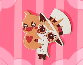 pequeno rei gremlin segurando um grande alfinete de esmalte de pato HH Lúcifer