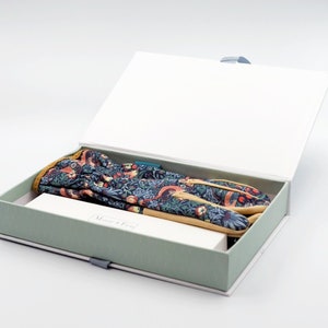 May include: A green and white box with a floral patterned gardening glove inside. The box is open and the glove is visible. The box has the text "Mouse & Feet" on the front.