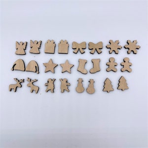 May include: A set of 18 wooden Christmas ornaments in various shapes, including angels, stars, presents, bows, snowflakes, reindeer, gingerbread people, snowmen, and Christmas trees.